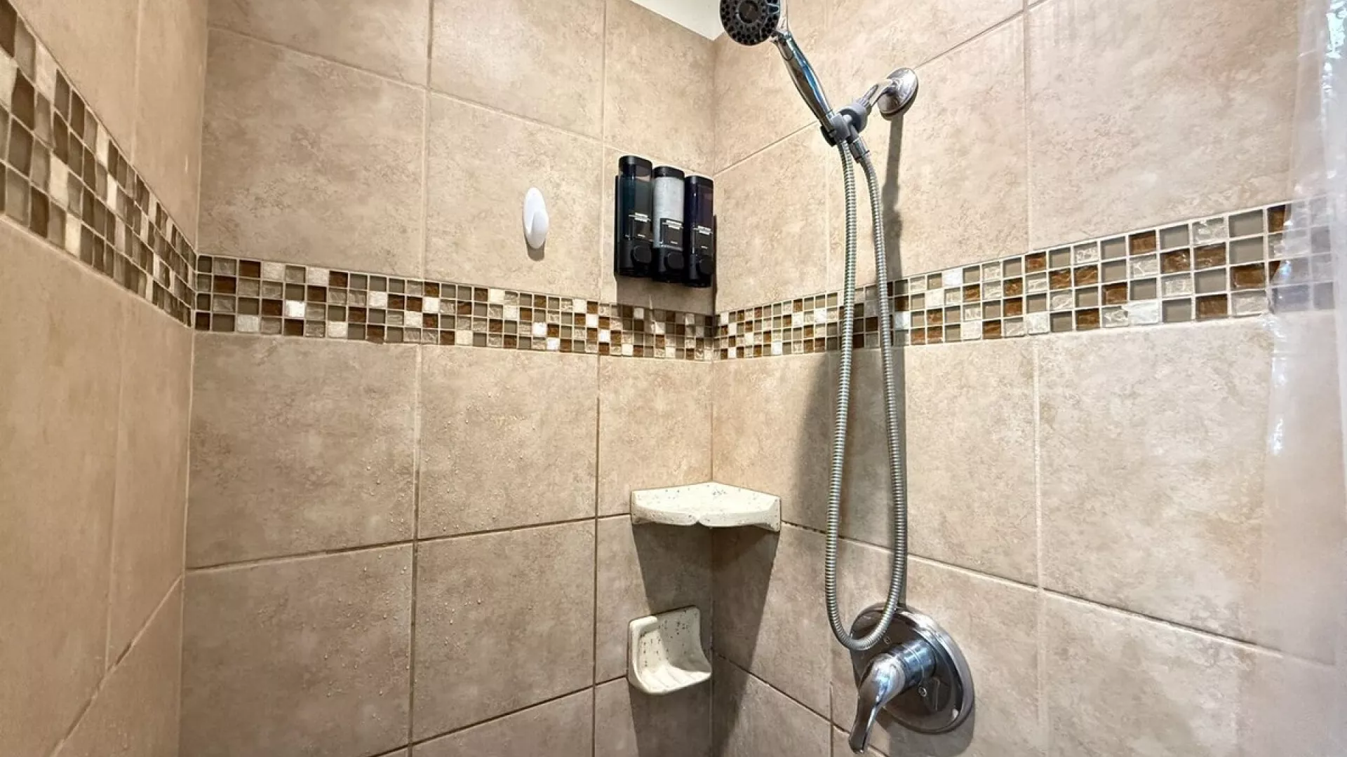 The standing shower is equipped with shampoo, conditioner, and body wash for you to use.