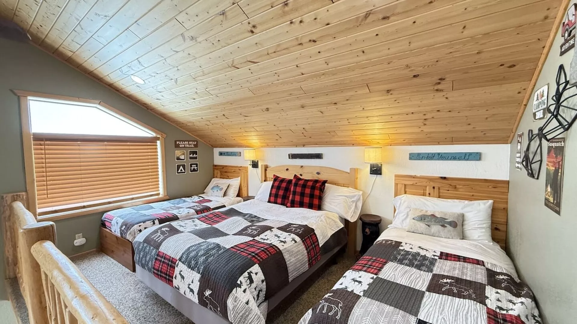Upstairs loft with a double bed and two twin beds.