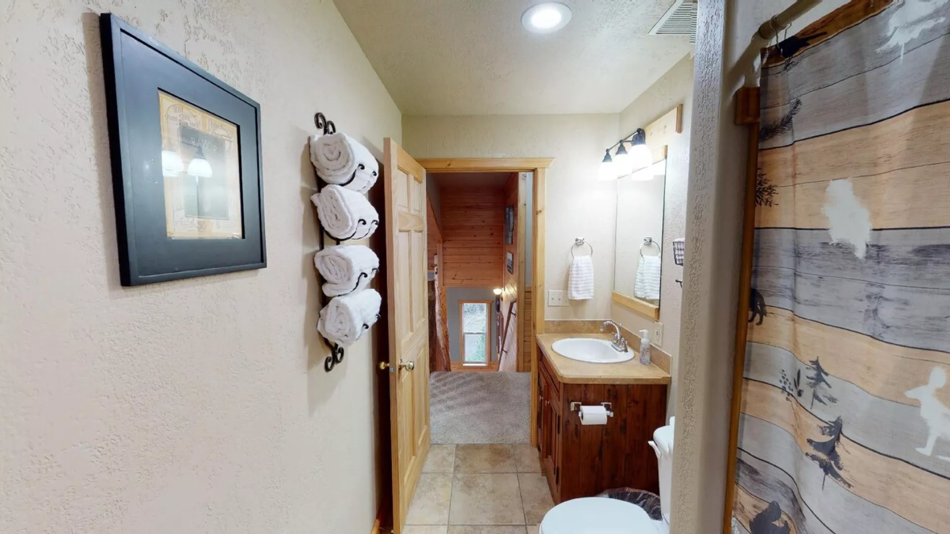 Towels, toilet paper, shampoo, conditioner, and body wash are provided in the bathroom.