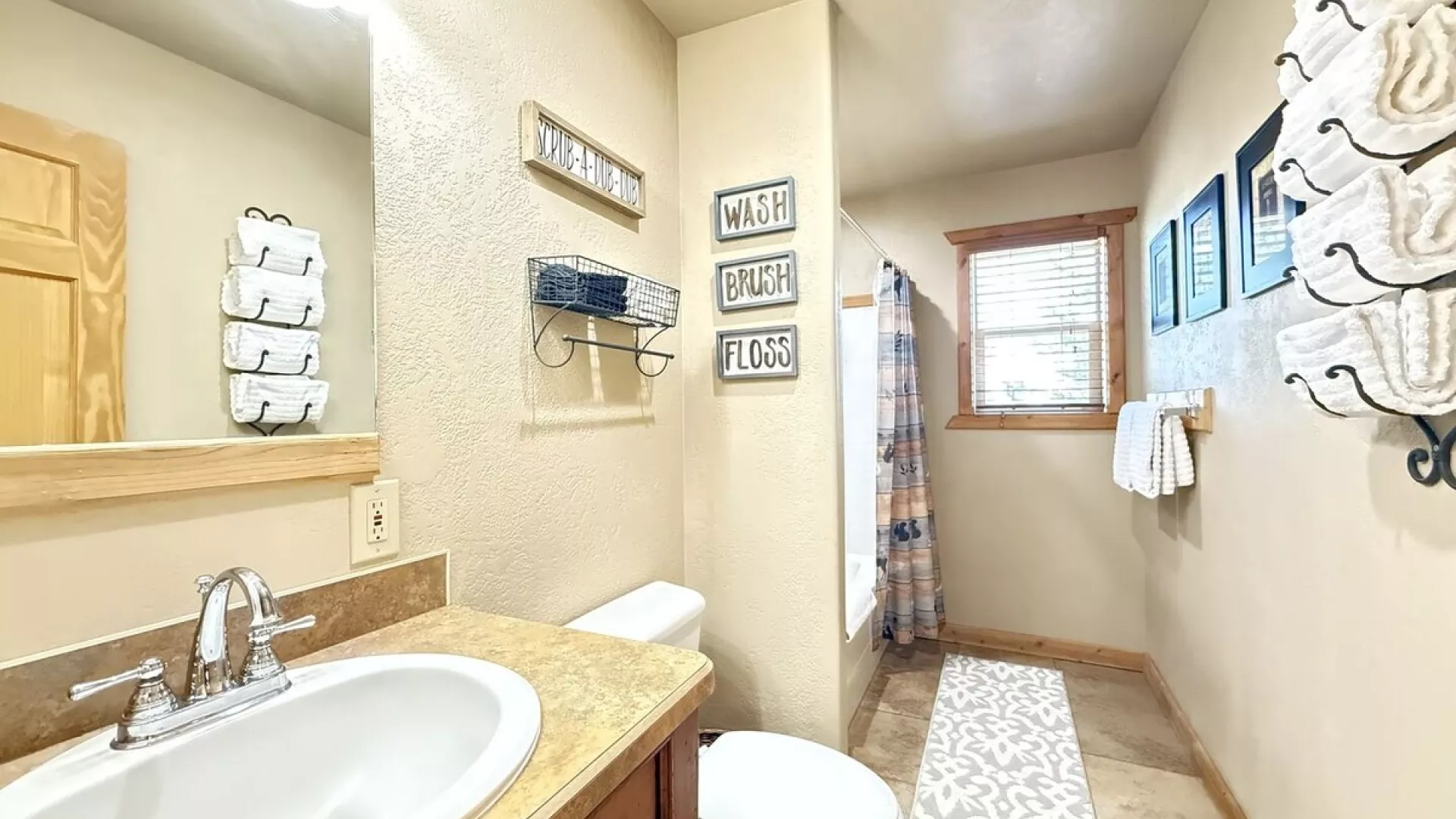 Upstairs bathroom with shower tub combo, toilet, and sink vanity.
