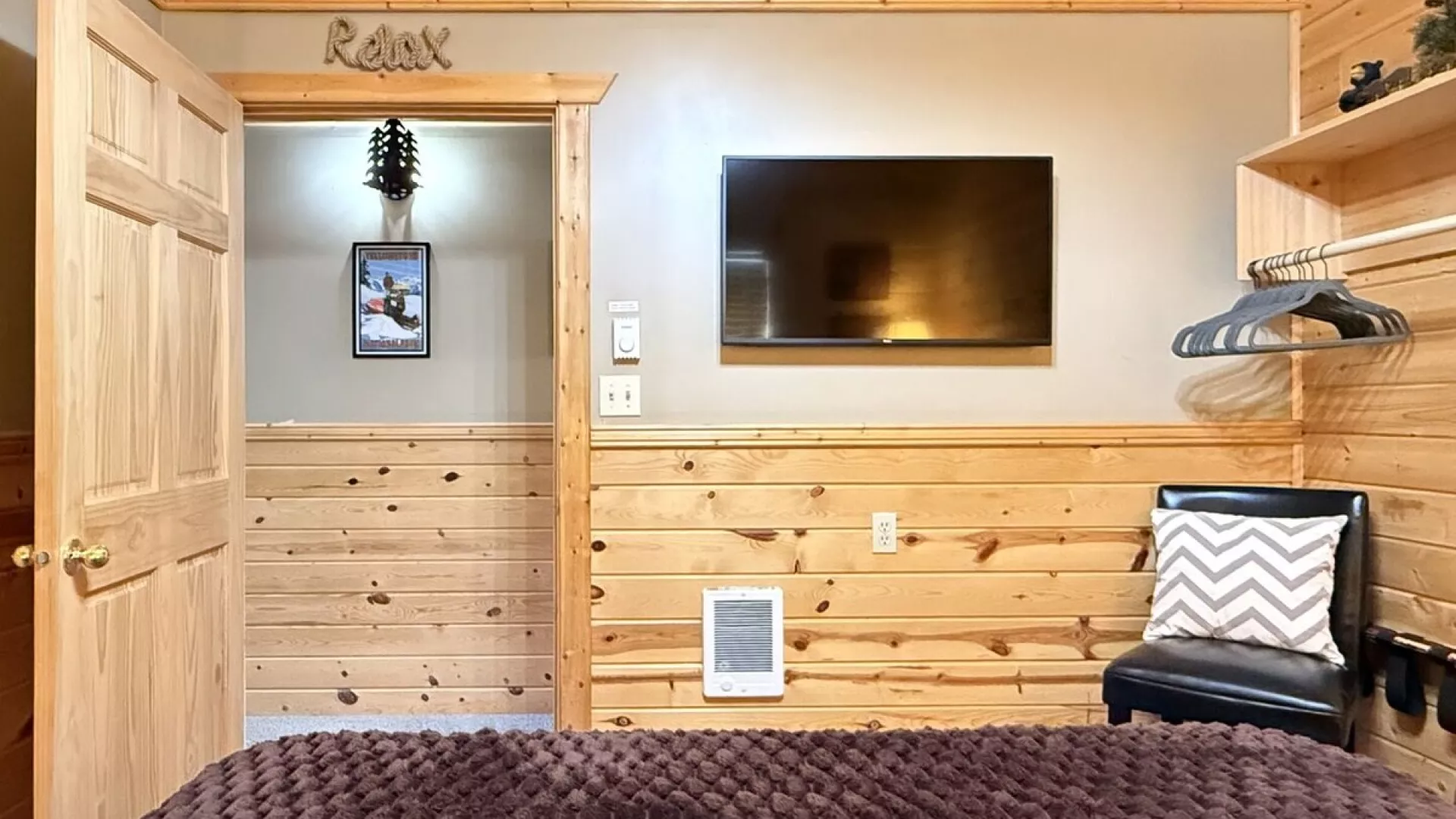 Across from the bed is a flat-screen TV—simple, unobtrusive, ready for late-night movies or quiet mornings.
