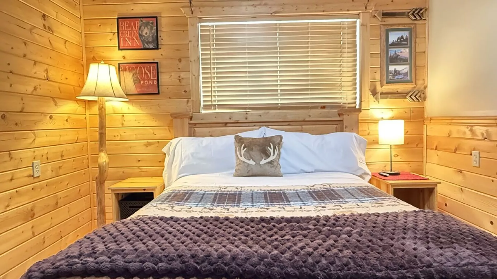 At the center of the room is a queen-sized bed with a chunky wood frame bringing that raw, rustic charm.