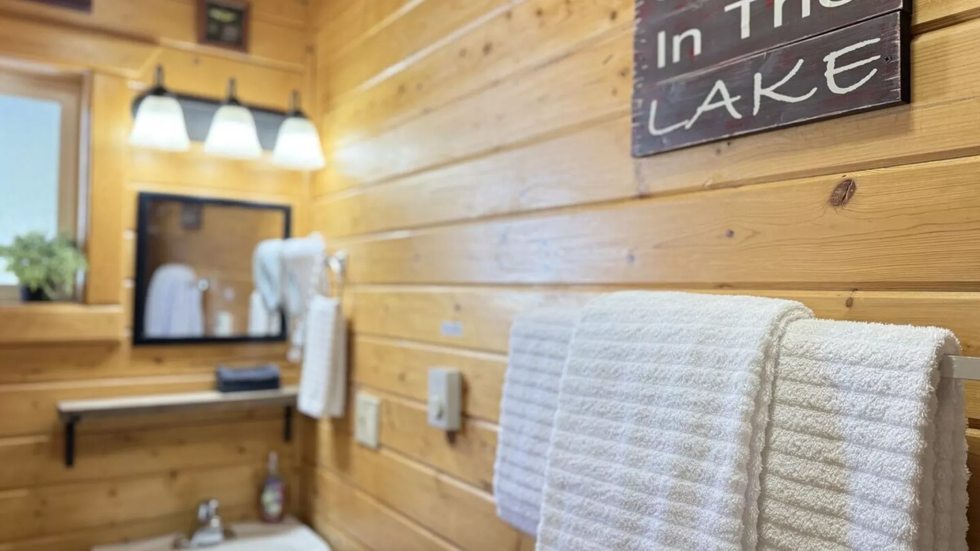 The second bathroom is equipped with a standing shower, sink, and a toilet.