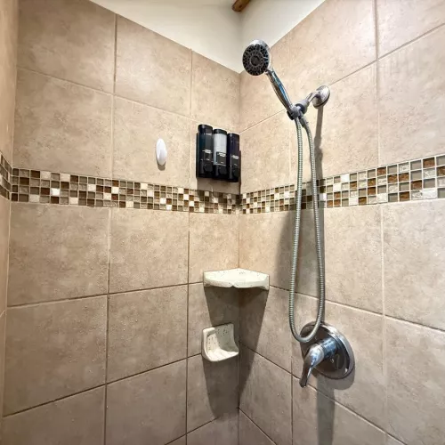 The standing shower is equipped with shampoo, conditioner, and body wash for you to use.