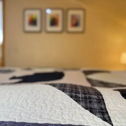 This bedroom feels like a serene sanctuary, offering a peaceful escape surrounded by nature.