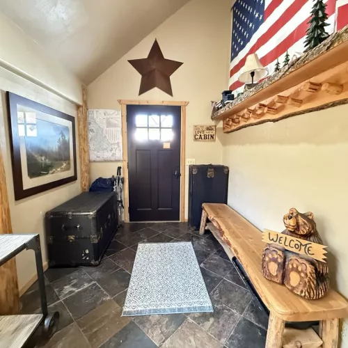 The entryway of the cabin has seating and storage during your stay.