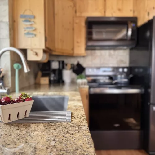 The kitchen in this cabin exudes warmth and practicality, designed for both comfort and functionality.