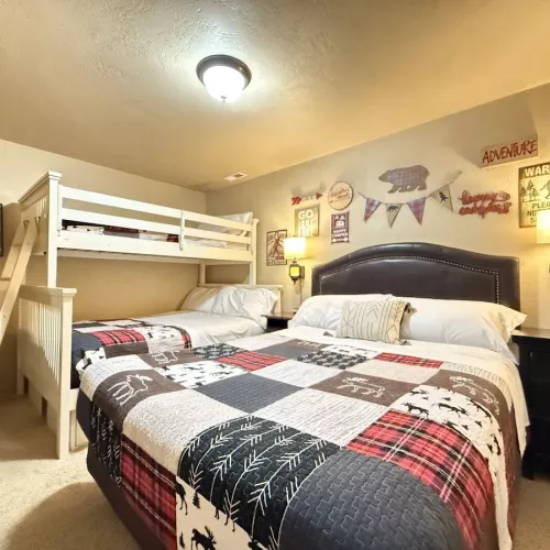 Downstairs bedroom #2, perfect for up to 5 people. This room features a queen bed and a bunk bed with a twin and double bed.