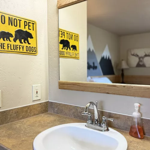 Sink and hand towel is located in this bedroom.