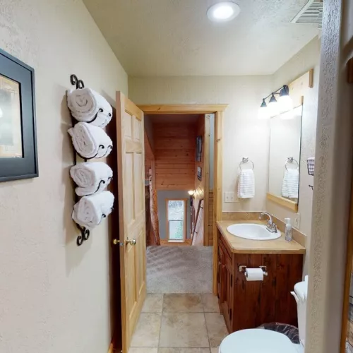 Towels, toilet paper, shampoo, conditioner, and body wash are provided in the bathroom.