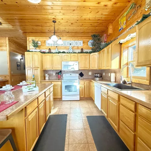 This kitchen is equipped with full appliances, basic cookware, dishes, and spices.