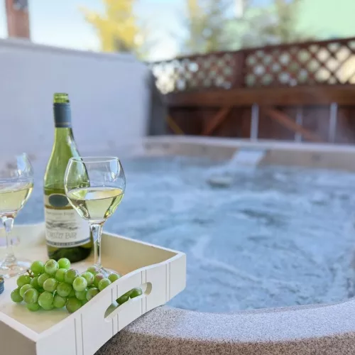 Unwind and relax in the hot tub that is located outside cabin.