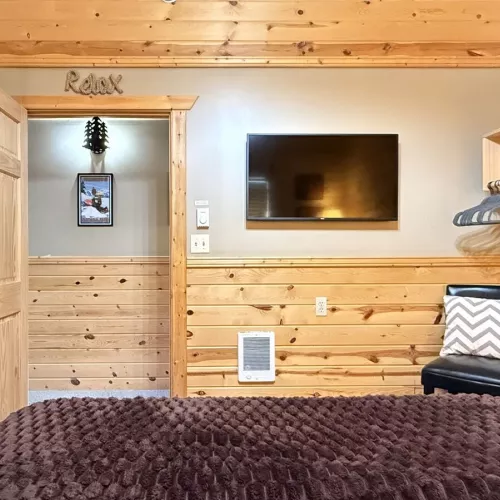 Across from the bed is a flat-screen TV—simple, unobtrusive, ready for late-night movies or quiet mornings.