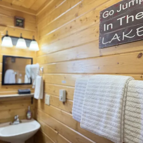 The second bathroom is equipped with a standing shower, sink, and a toilet.
