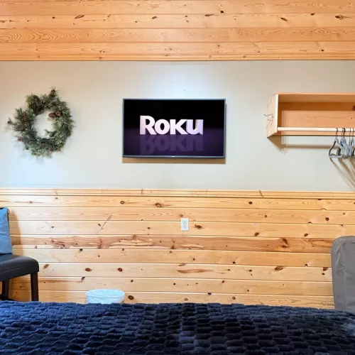 Across from the bed is a flat-screen TV—simple, unobtrusive, ready for late-night movies or quiet mornings.