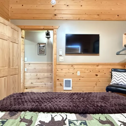 Across from the bed is a flat-screen TV—simple, unobtrusive, ready for late-night movies or quiet mornings.