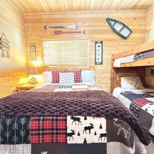 Welcome to the third bedroom with a queen bed and 2 twin beds on a bunk bed.