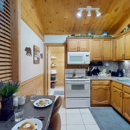 A full kitchen with appliances and dining table to enjoy.